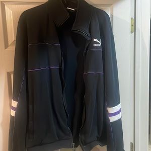Black, white, and purple zip-up puma jacket with puma decal on the back.